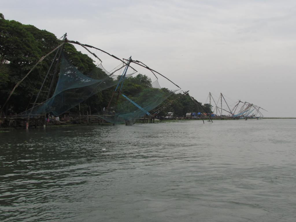 Fishing nets at Fort Cochin. It is interesting to see the process of catching fish. The large net moves down in the water. It is controlled by several people .